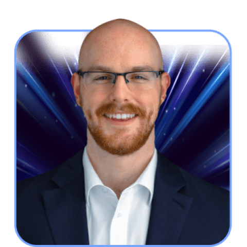 Bald man in glasses with a blue background.