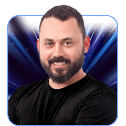 Man smiling, dark shirt, abstract blue background.