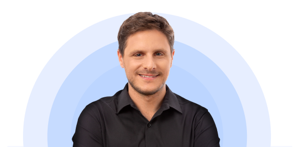 Man smiling with a circular blue background.