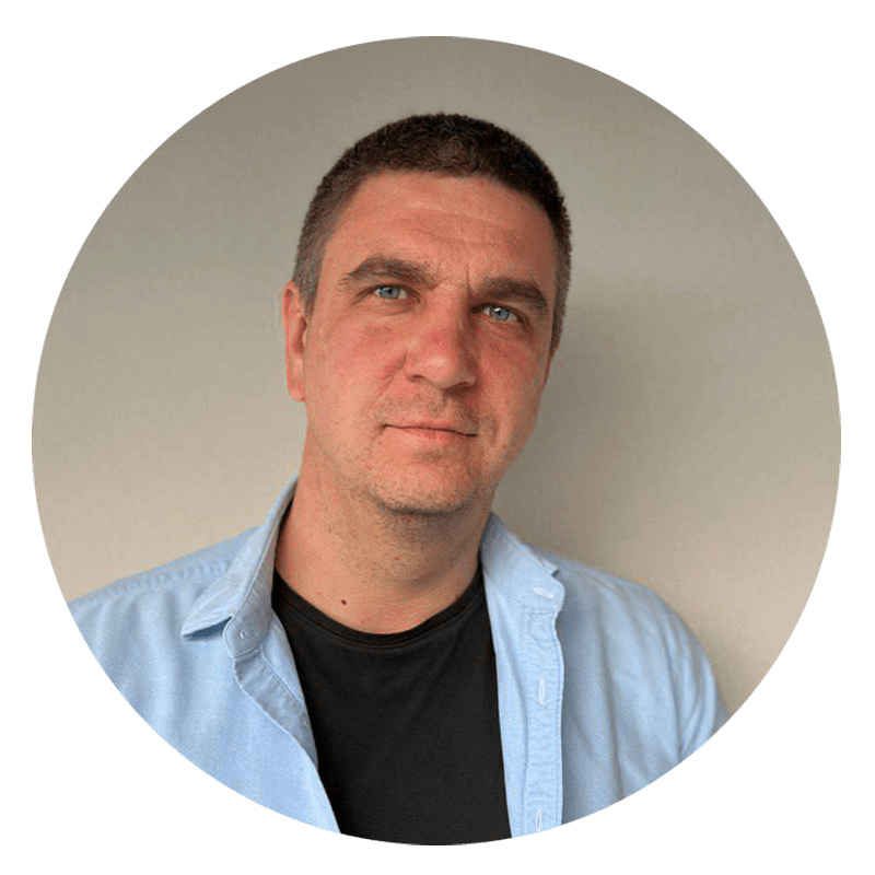 Man wearing light blue shirt and black T-shirt.