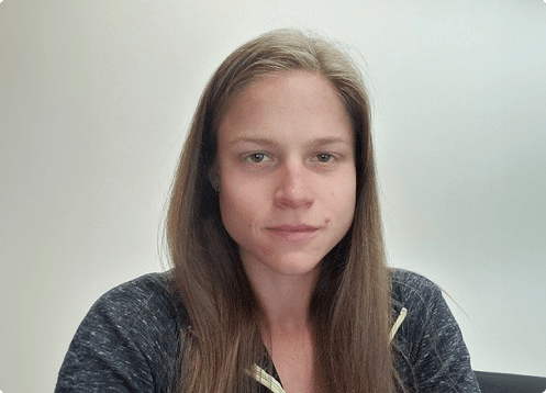 Woman with long hair and serious expression.