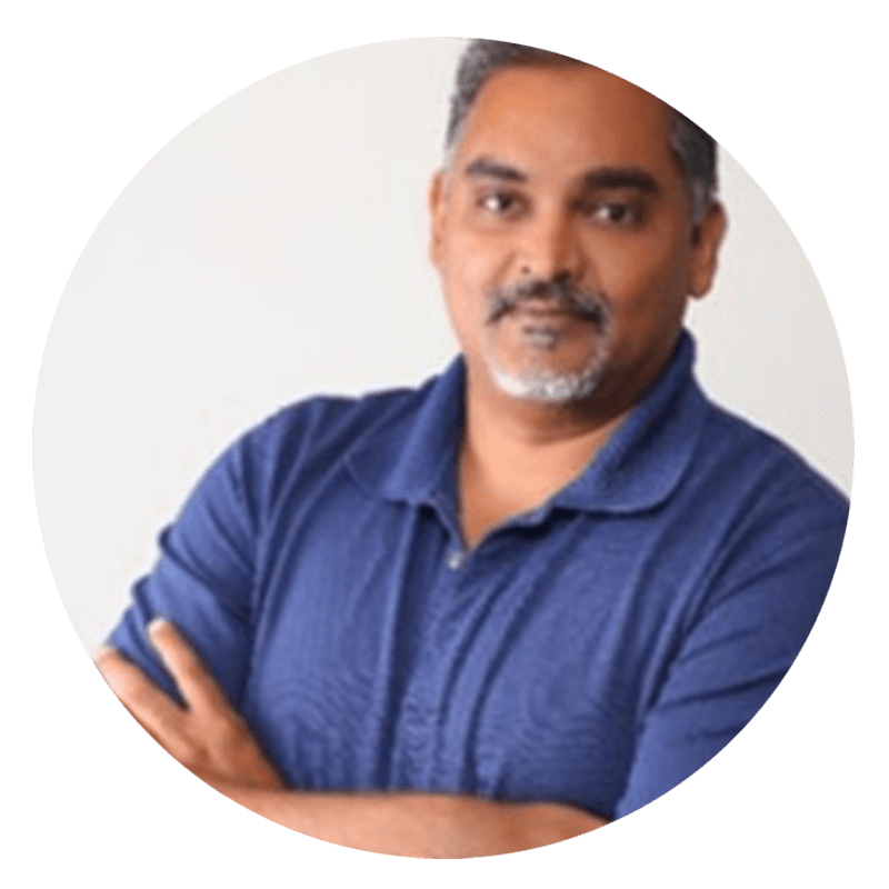 Man in blue shirt with arms crossed.